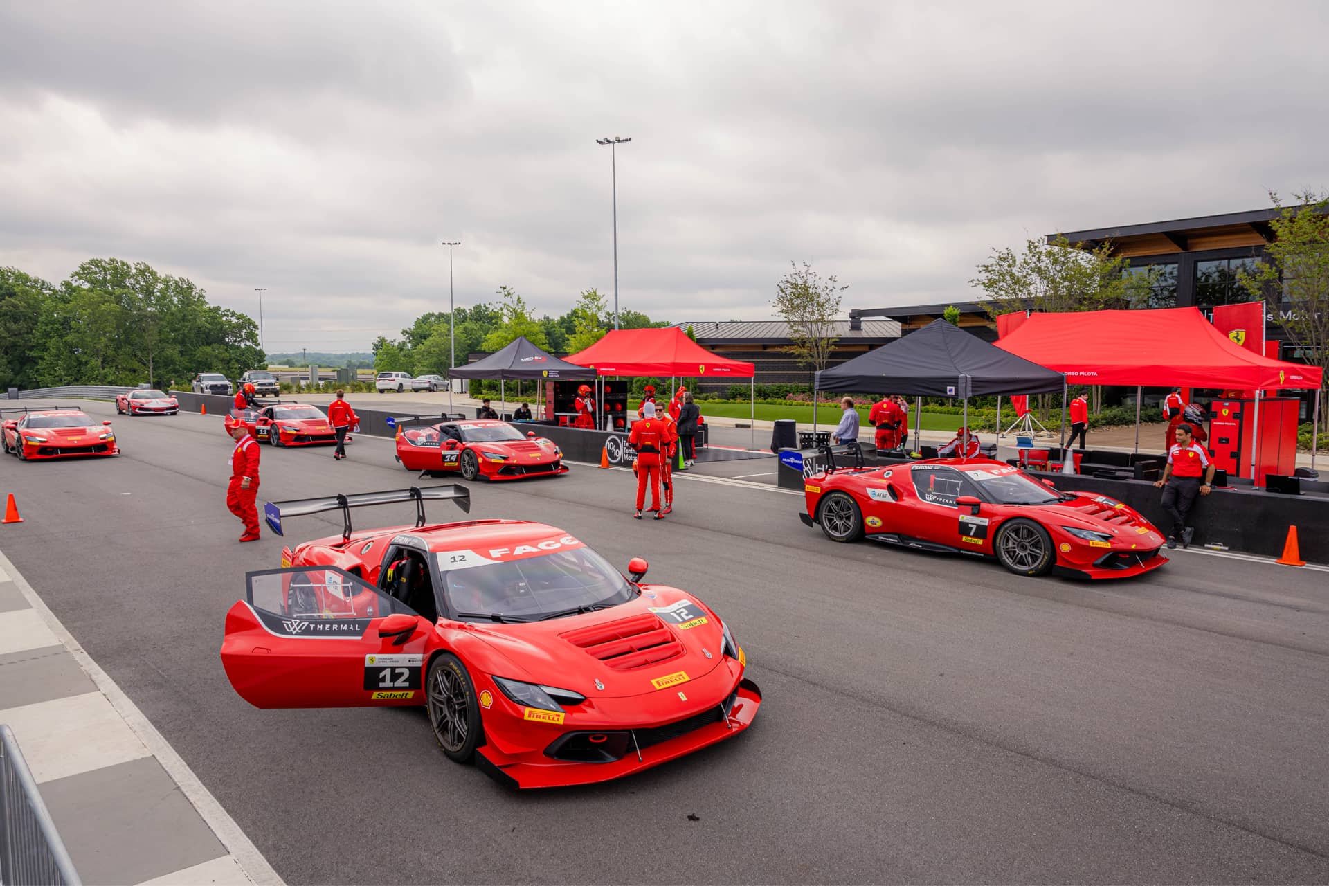 Ferrari 296 Challenge cars rolling out of pit lane at Ten Tenths