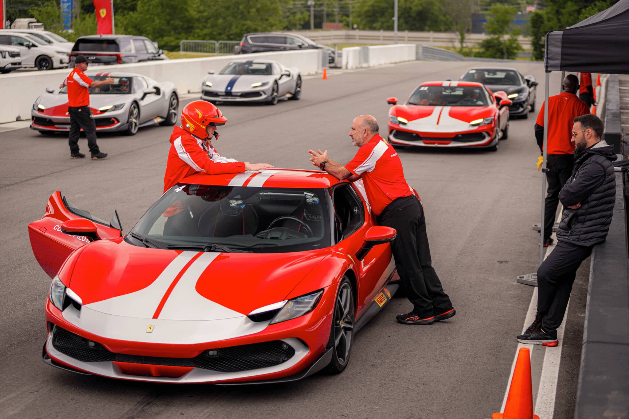Two men leaning over a Ferrari