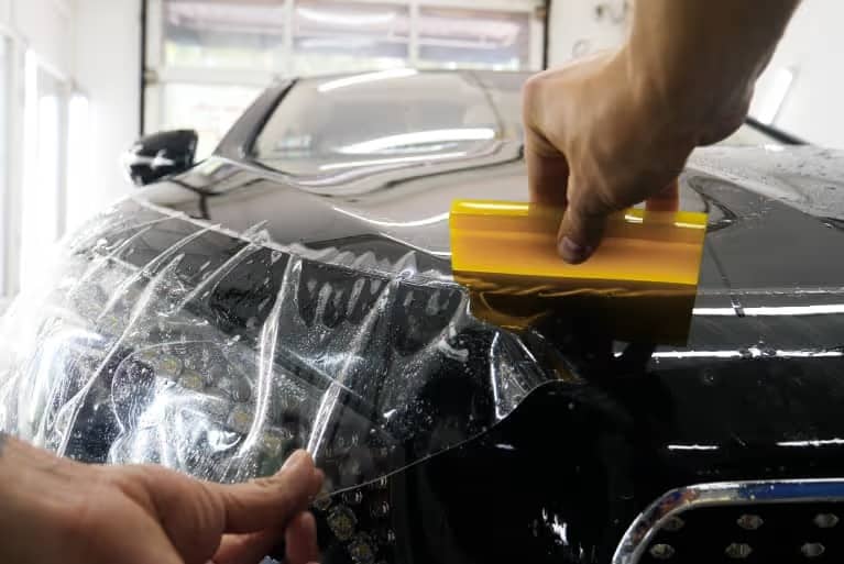Protective layer being added to car