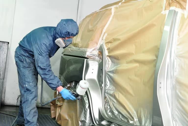 Spraying new paint on body